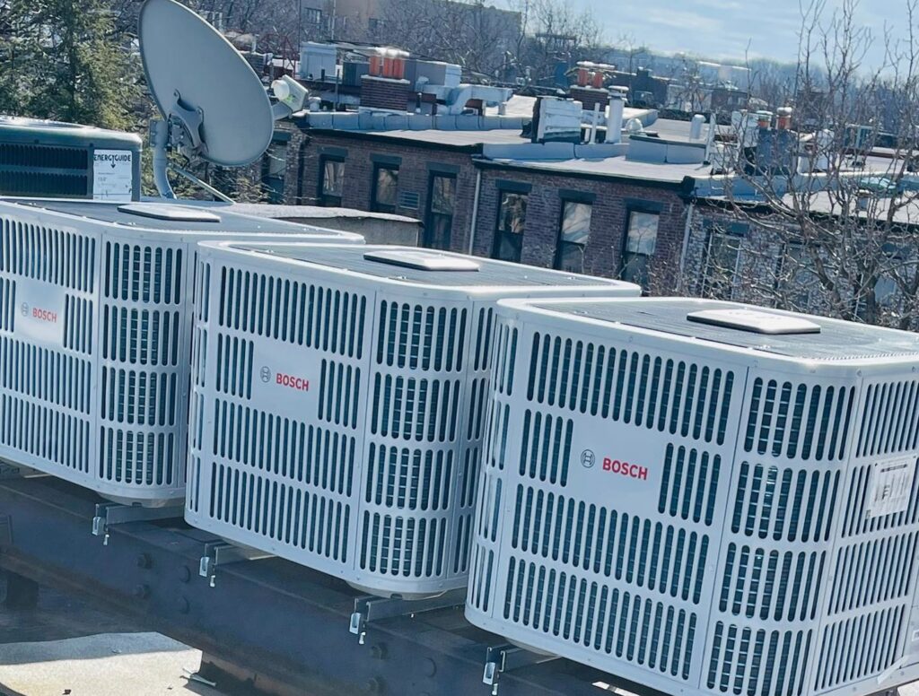 Several Bosch outdoor HVAC condenser units installed on a commercial rooftop by Deboque Duct Design Corp. in Staten Island, NY