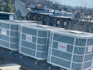 Several Bosch outdoor HVAC condenser units installed on a commercial rooftop by Deboque Duct Design Corp. in Staten Island, NY