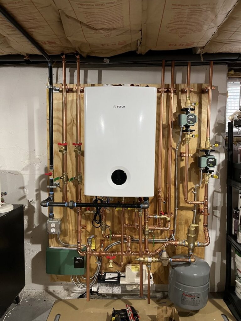 A new Bosch tankless water heater installation with copper piping by Hampden County HVAC Inc. in Indian Orchard, MA