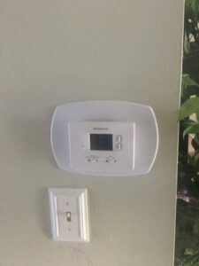 A Braeburn digital thermostat installed on a wall by JDL HVAC Services, LLC in Laurel, MD.