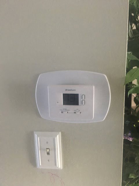 A Braeburn digital thermostat installed on a wall by JDL HVAC Services, LLC in Laurel, MD.
