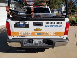 Rear view of the branded service truck for 170 Springs LLC Garage Doors, equipped for jobs in Aurora, CO