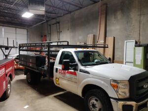 A branded service truck of CCM Overhead Doors parked inside their warehouse in Oklahoma City, OK