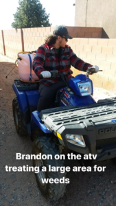 Brandon, a technician, on an ATV performing weed treatment for Ecotec Pest Control in Rio Rancho, NM.