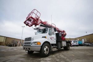 A Brase Electrical Contracting Corp bucket truck parked on a job site in Omaha, NE, ready for electrical work.