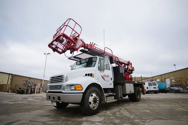 A Brase Electrical Contracting Corp bucket truck parked on a job site in Omaha, NE, ready for electrical work.