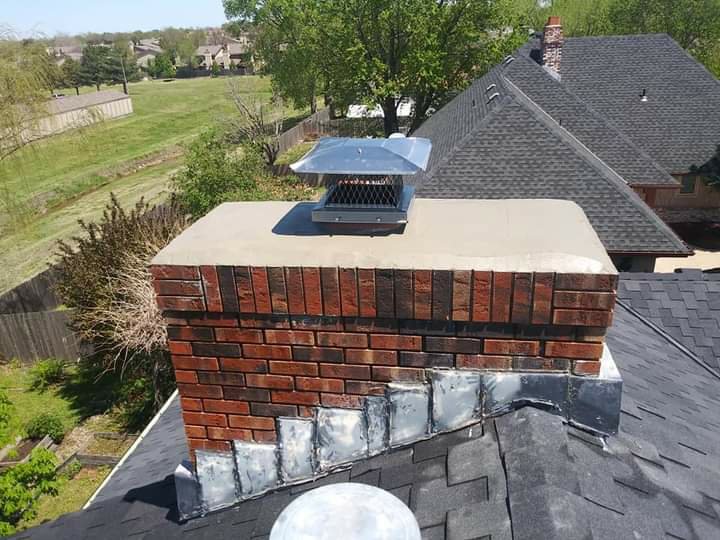 A well-maintained brick chimney with a new metal cap installed by A Step Above Chimney & Siding in Wichita, KS.