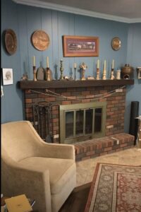A traditional brick fireplace with a metal insert, maintained by Chimney Mechanix of Indiana in Lafayette, IN.