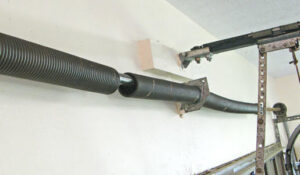 A close-up view of a broken garage door spring, indicating a necessary repair service by Max Garage Door in Minneapolis, MN.