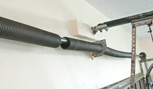 A close-up view of a broken garage door spring, indicating a necessary repair service by Max Garage Door in Minneapolis, MN.