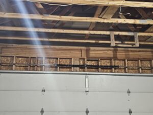 A broken garage door torsion spring system, indicating a need for repair by Garage Gecko in Spokane, WA.