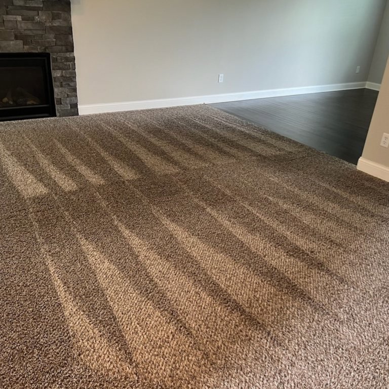 Brown carpet showing fresh cleaning lines in a living area, cleaned by Dewdrop Carpet Cleaning in Kansas City, MO.