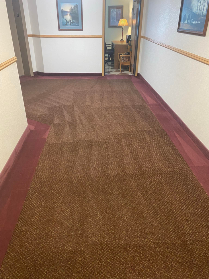 A freshly cleaned brown carpet in a commercial hallway, showcasing professional results by Agwa's carpet core in Minneapolis, MN.