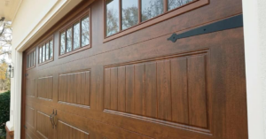 A close-up of a newly installed brown garage door with windows and decorative hardware by Mike's Garage Door Repair in Wetumpka, AL.