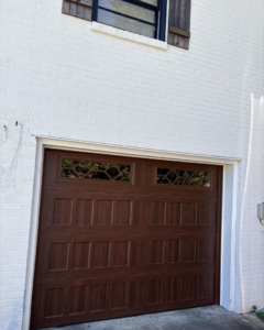 A stylish brown garage door with decorative windows installed by Gilliam Services LLC in Johnson City, TN.