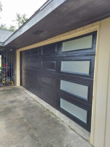 A brown garage door with multiple windows being installed by Residential WorX LLC in Westlake, LA.