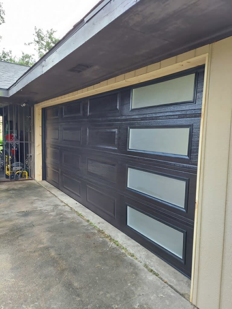 A brown garage door with multiple windows being installed by Residential WorX LLC in Westlake, LA.