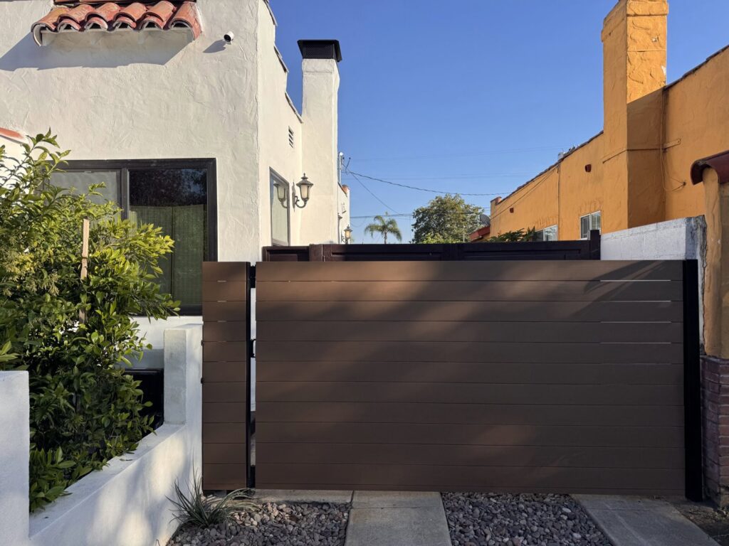 A modern brown horizontal slat gate providing privacy and security, installed by Harwell Fencing & Gates Inc. in Los Angeles, CA.