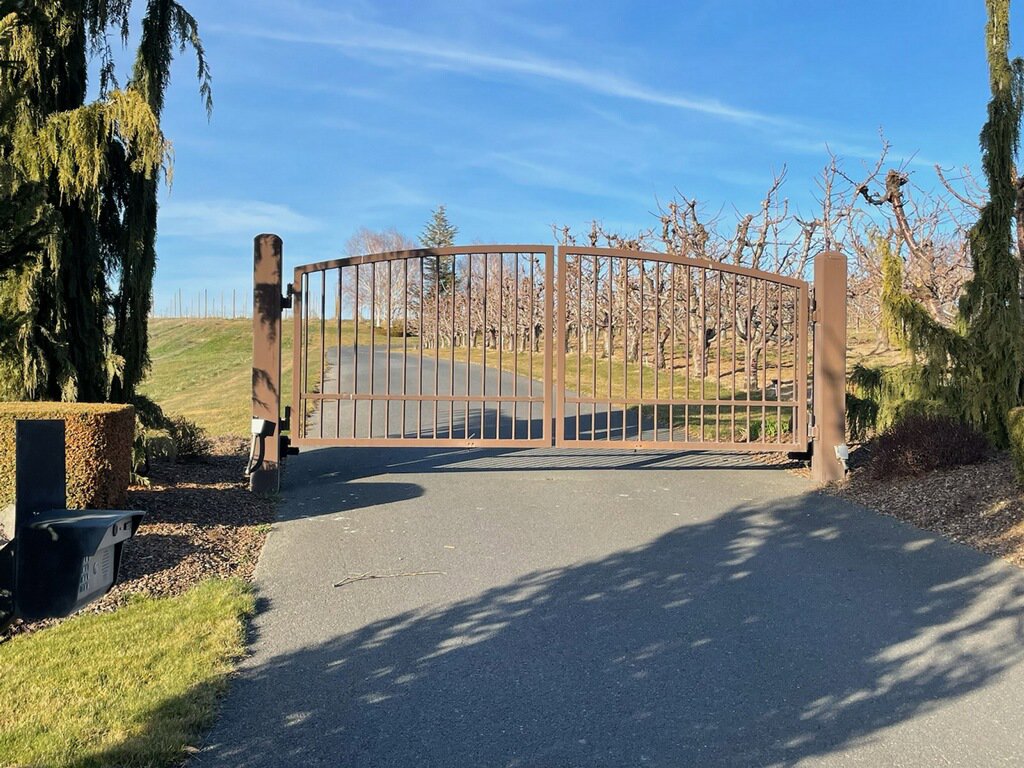 A brown ornamental driveway gate installed by Integrity Gates and Fencing in Yakima, WA