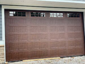 A stylish brown panel garage door with decorative windows installed by Rose Quality Garage Doors in Murfreesboro, TN