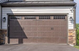 A stylish brown panel residential garage door with windows installed by Summers Garage Door in Denver, CO.