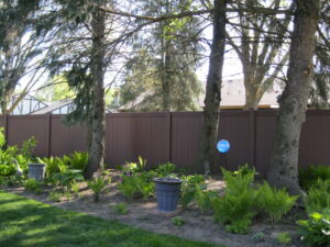 A sturdy brown privacy fence installed in a residential backyard by Metrofence in Grand Rapids, MI.