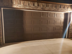 A brown residential garage door installation completed by Zee's Garage Doors in Oklahoma City, OK.
