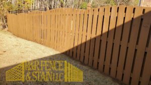A brown-stained wood privacy fence installed by R&R Fence & Stain LLC in Madison, AL.
