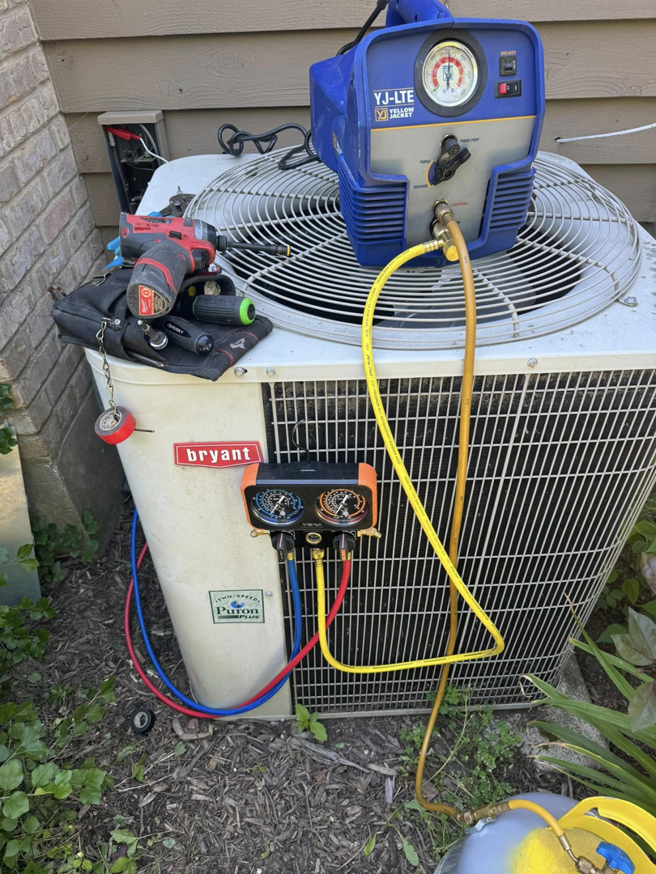 A Bryant AC unit receiving refrigerant service with specialized tools by Four Stages, an HVAC contractor in Chicago, IL.