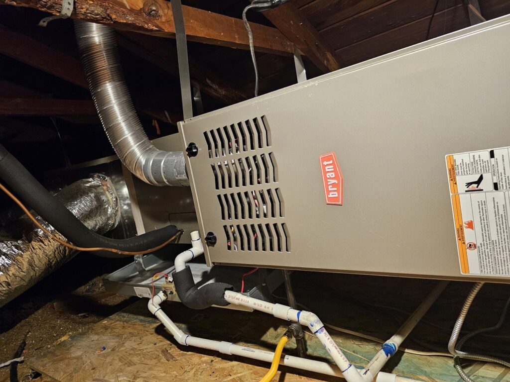 A Bryant furnace or air handler unit installed in an attic with ductwork by MasterCraft Mechanical, LLC. in Haslet, TX.