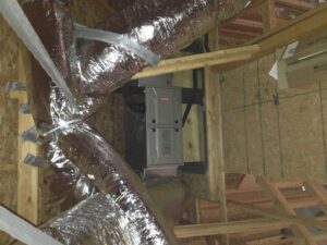 A Bryant furnace and air handler unit installed in an attic with ductwork by Rhino Heating and Air Conditioning LLC in Norman, OK.
