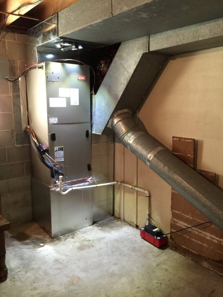 A Bryant furnace or air handler unit with extensive ductwork installed in a basement by Douglas Cooling & Heating in Pelham, AL.