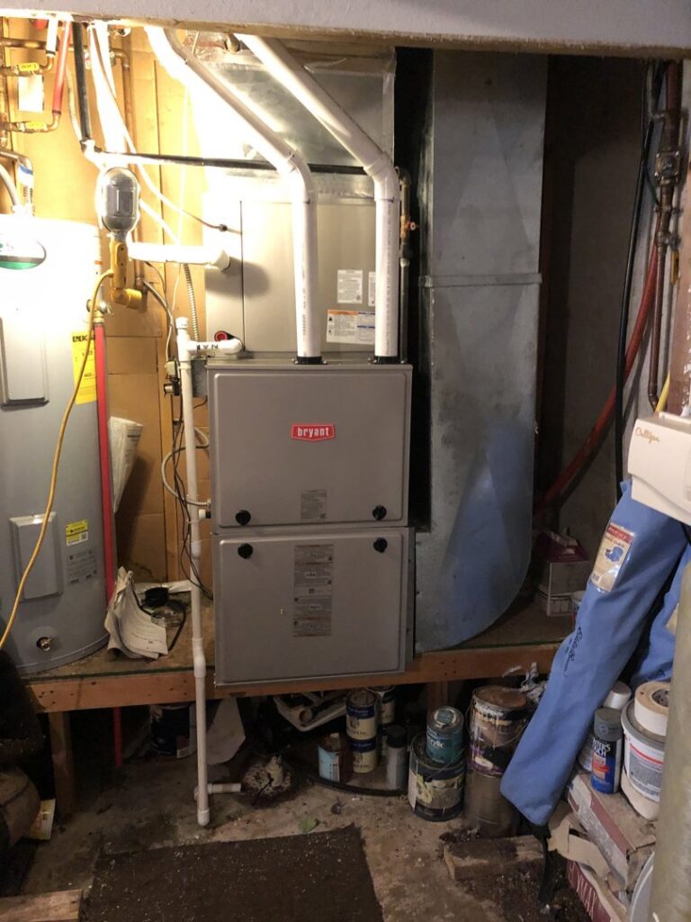 A Bryant furnace unit and water heater installed in a utility room by 4-BIS Solutions HVAC and Home Maintenance in Columbia, MO.