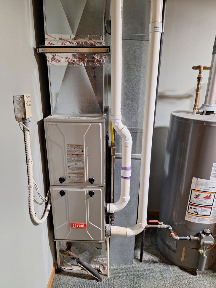 A Bryant furnace and water heater installation with ductwork and piping by Fine Line HVAC LLC, providing heating in Isanti, MN.