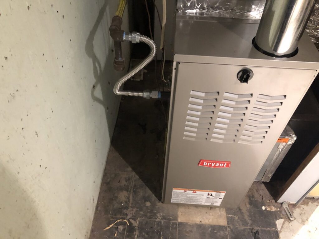 A Bryant brand furnace unit with gas lines and ductwork installed by Air Done Right in Philadelphia, PA.