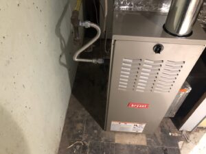 A Bryant brand furnace unit with gas lines and ductwork installed by Air Done Right in Philadelphia, PA.