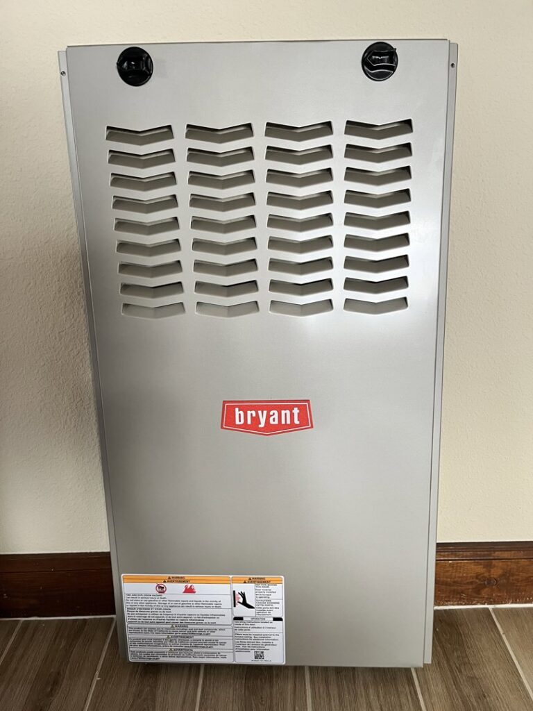 A newly installed Bryant furnace and air handler unit against a wall by Aircon Heating and Cooling Inc in Las Cruces, NM