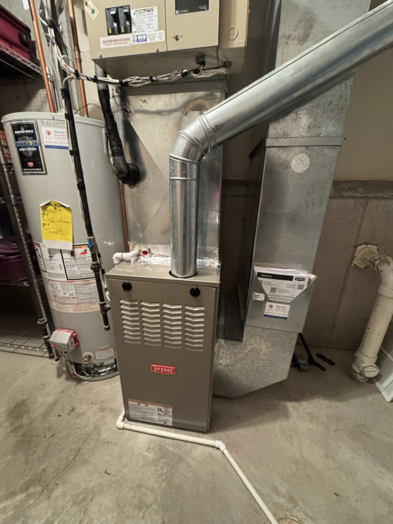A Bryant furnace and water heater installed in a utility area by Golden Heating and Air LLC in Arvada, CO.