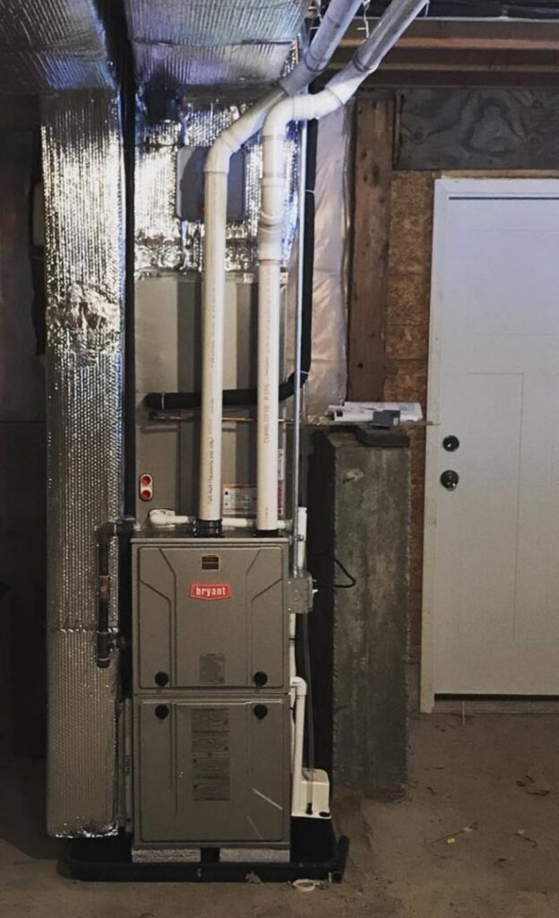 A Bryant furnace and insulated ductwork installed in a utility room by Massachusetts Pro HVAC in Shrewsbury, MA.