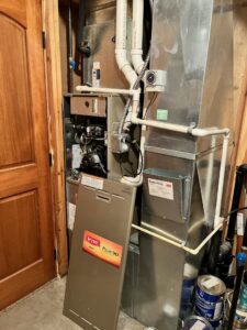 An indoor Bryant Plus 90 furnace with its cover removed, showing internal components, serviced by PNW Spokane Heating and Air in Spokane, WA.