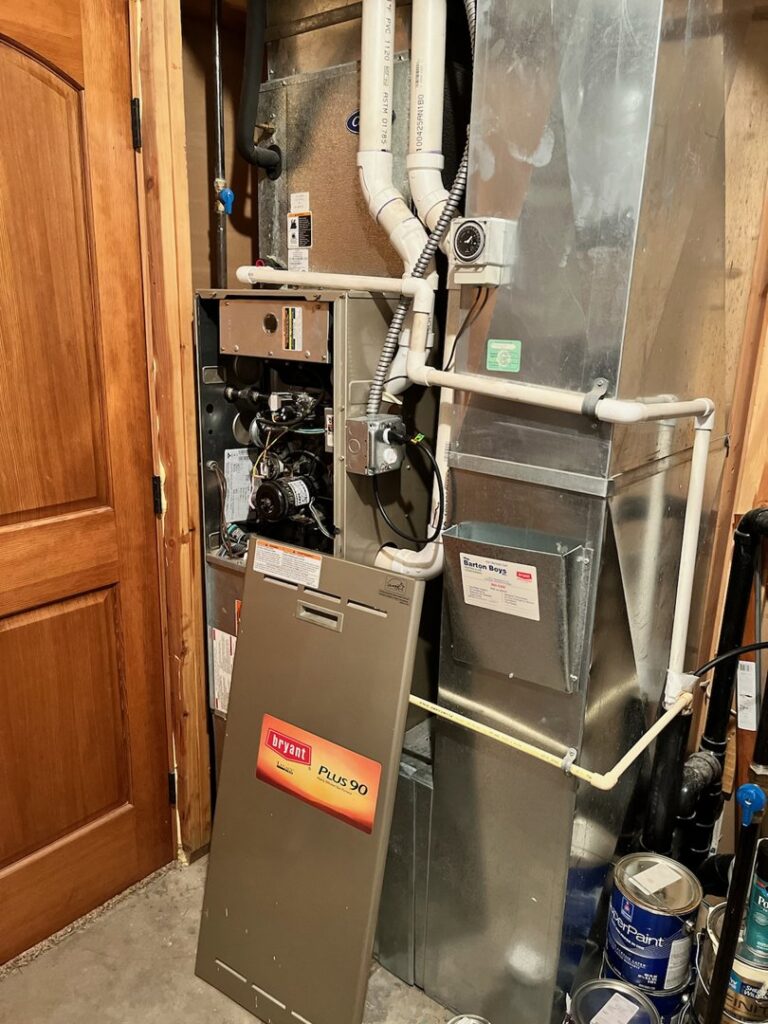 An indoor Bryant Plus 90 furnace with its cover removed, showing internal components, serviced by PNW Spokane Heating and Air in Spokane, WA.