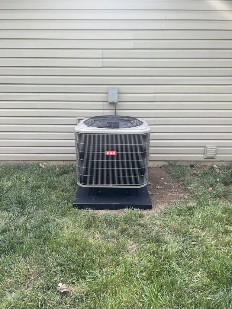 A Bryant outdoor air conditioning unit installed next to a home by 4-BIS Solutions HVAC and Home Maintenance in Columbia, MO.