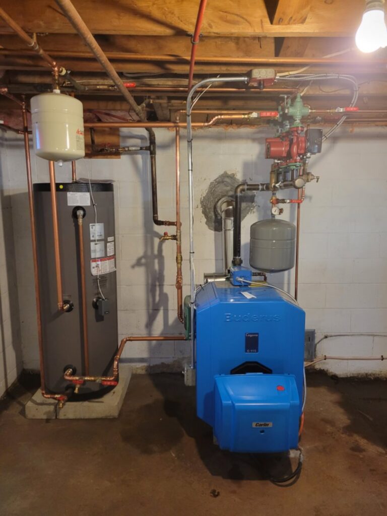 A Buderus boiler and water heater installation with copper piping by Hampden County HVAC Inc. in Indian Orchard, MA