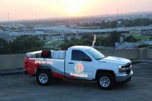 A branded Bug Busters Pest Control truck with city views in the background, representing services in San Antonio, TX.