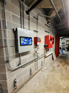 A building automation system control panel and piping installed by ICM Mechanical & Controls, LLC in Fall River, MA