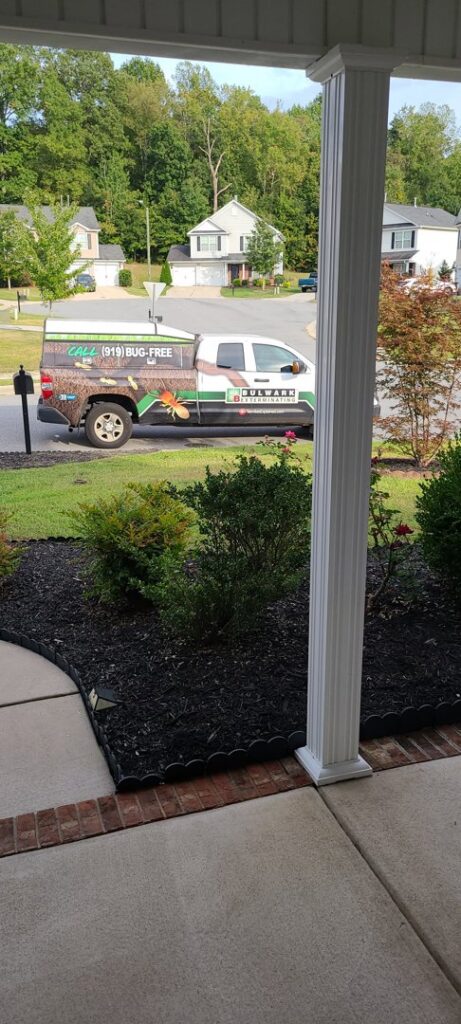 A Bulwark Exterminating service truck parked at a residential property in Greensboro, NC.