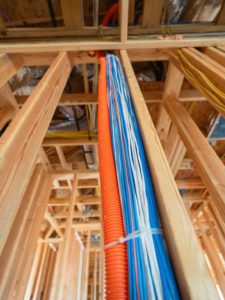 Bundled electrical cables and conduit during rough-in installation by Powered Solutions in Farmers Branch, TX