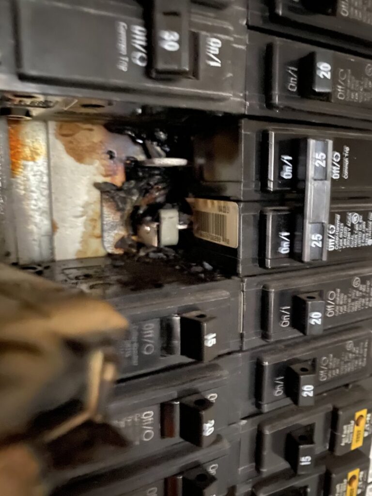 A burnt circuit breaker indicating an electrical fault, requiring repair by Phoenix Electric, Inc. in Cape Coral, FL