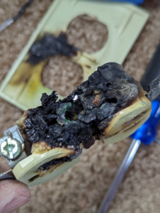A close-up of a burnt and damaged electrical outlet requiring repair by The Wire Guy in San Jose, CA.