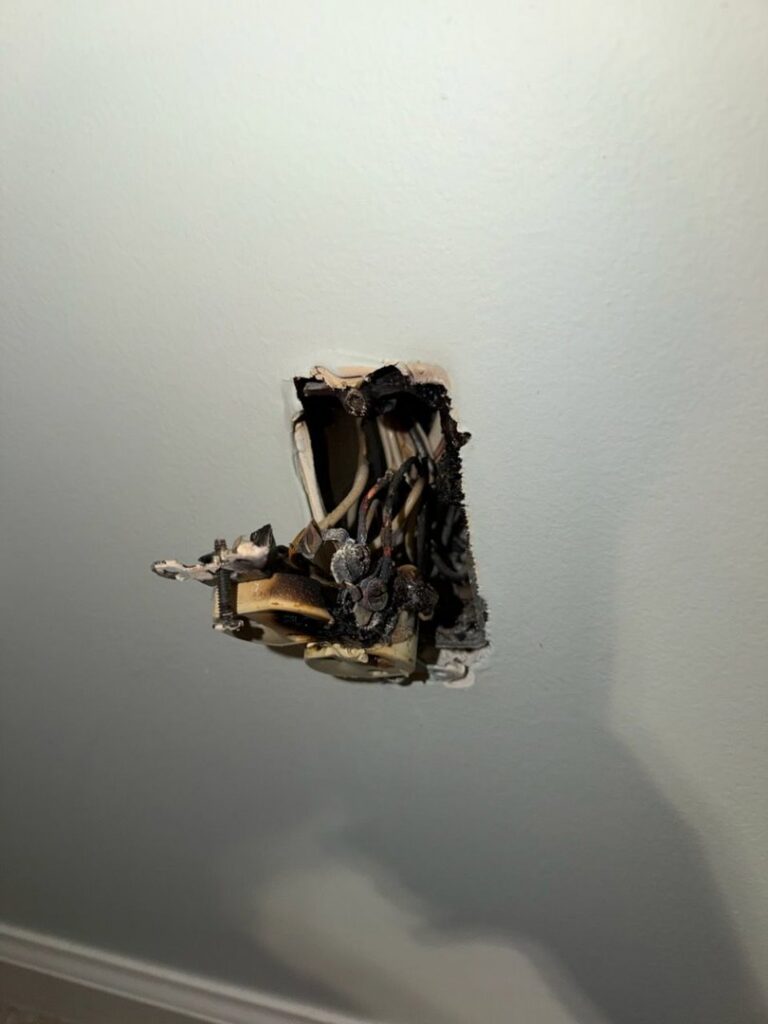 Burnt electrical outlet requiring repair by Power'd Up Electric, LLC in Clinton, TN.